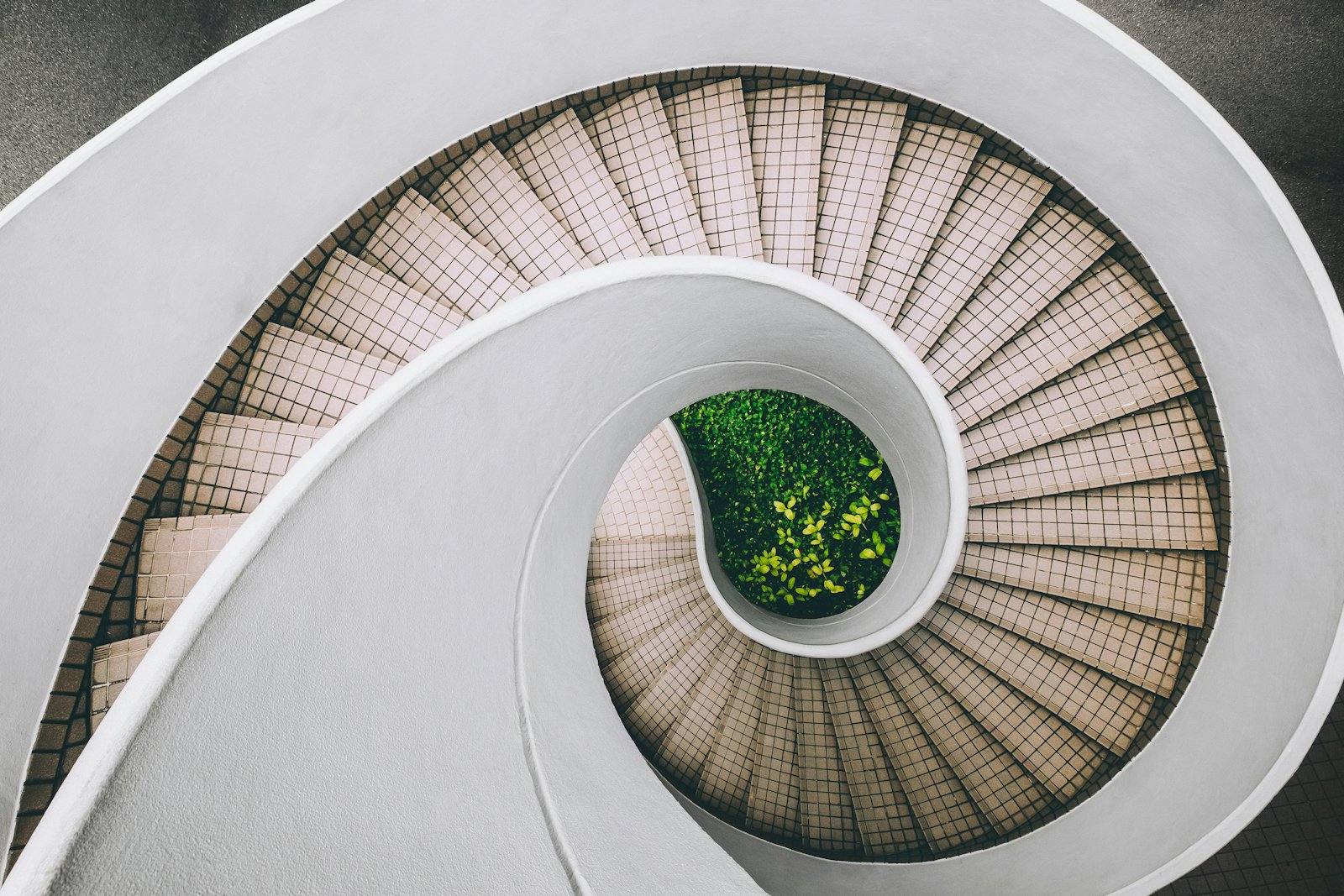 Looking down a white spiral staircase