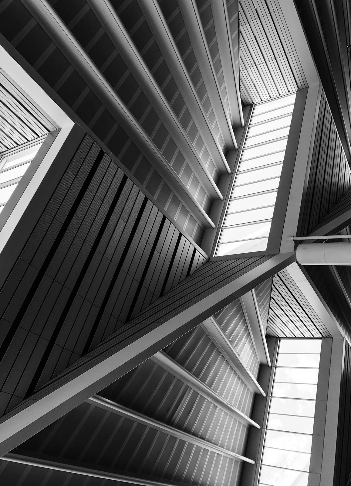 Looking up through a white steel frame structure